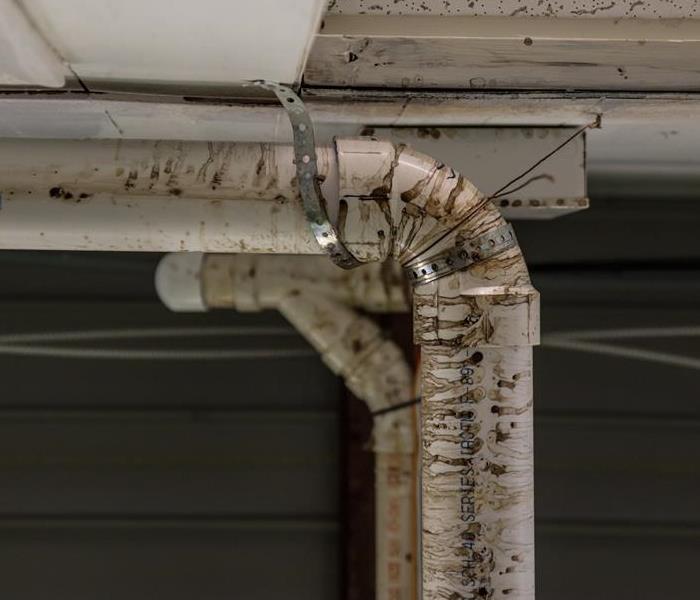 This closeup shot of the drain pipe shows the damage done from the water that leaked from it. 