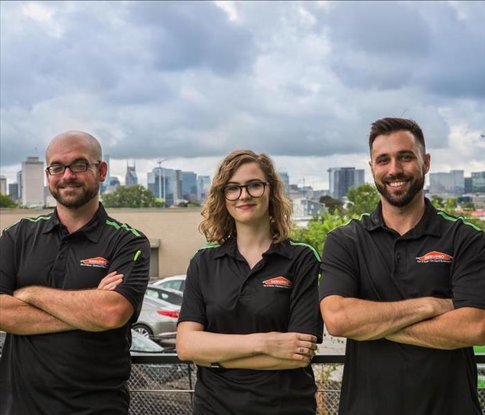 three SERVPRO employees with their arms crossed