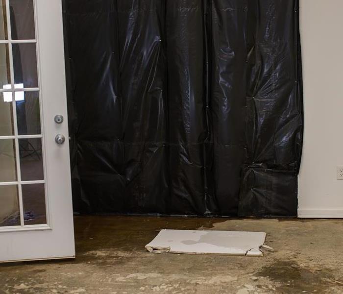 Vacant room with tarp for odor removal
